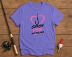 Purple t-shirt with fishing-themed design on a wooden surface with fishing equipment.
