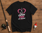 Black t-shirt with 'Catch Fish Not Feelings' design on a wooden surface with fishing equipment.