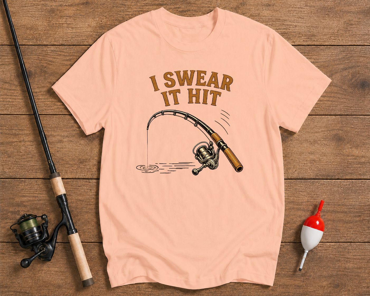I Swear It Hit fishing t-shirt in salmon featuring a humorous fishing rod illustration by Funky Fish Club